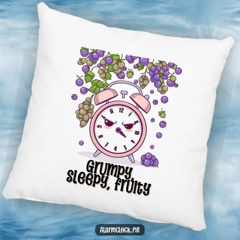 Funny pillow showcasing a grumpy alarm clock being pelted by tiny grapes, adding a humorous and comfortable touch to any room.